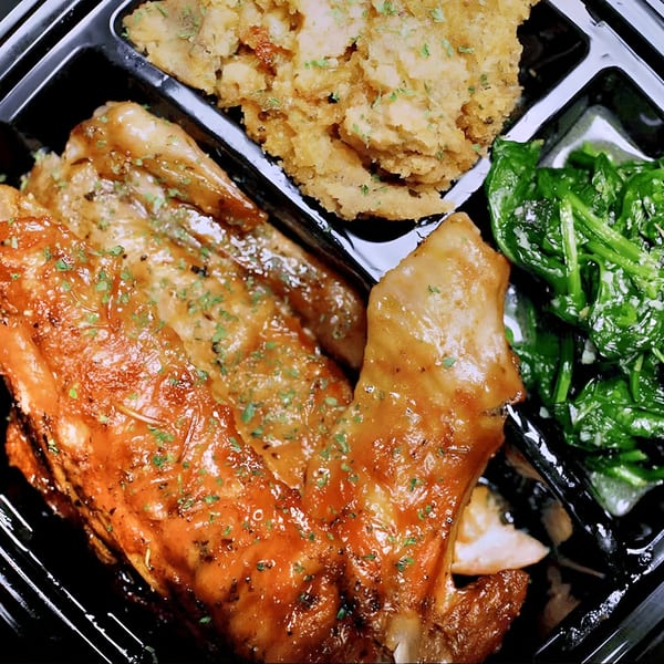 Victoria's Kitchen & Catering soul food meal with glazed chicken, mashed potatoes, and collard greens.